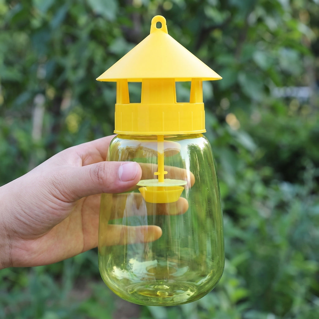 FlyLock Indoor and Outdoor Fruit Fly Trap held in one hand, about 20 cm tall and about 9 cm wide